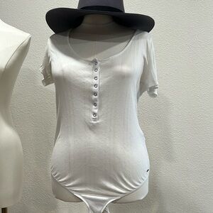 Women's philanthropy, white button up one piece body suite